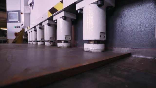 Guillotine cuts steel sheet. Hydraulic press. 4k footage. 
