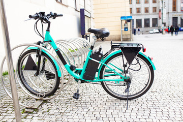 Modern Electric bike at bicycle parking alone on the old city street