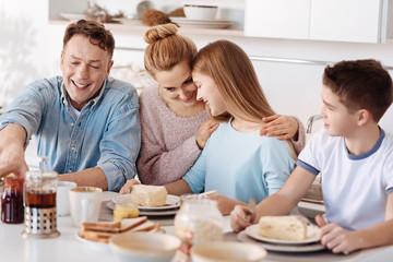 Obraz na płótnie Canvas Positive family enjoying their breakfast