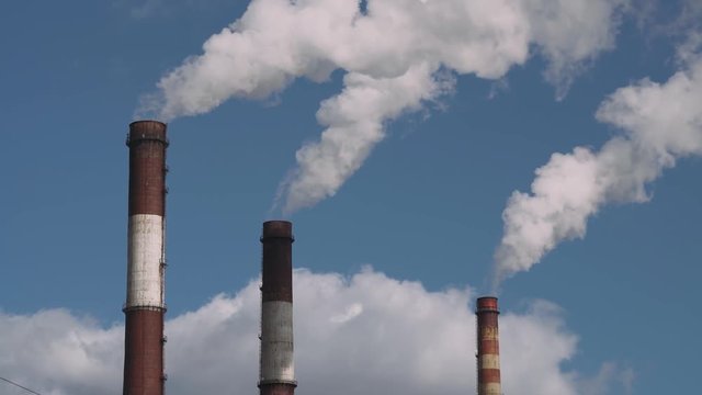 CHP Industrial landscape, smoke comes from pipes. 4k footage.
