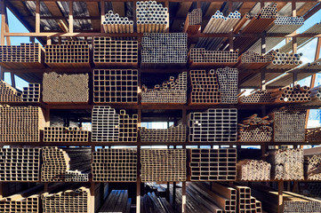 Racks full of rusty steel pipes outdoors