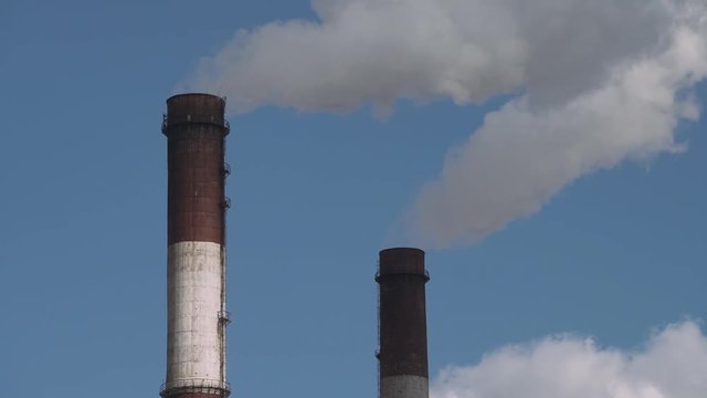 CHP Industrial landscape, smoke comes from pipes. 4k footage.
