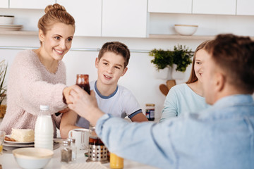 Positive couple having breakfast with their children