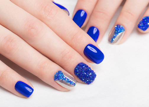 Beautifil blue manicure with rhinestone.. Nail Design. Close-up.