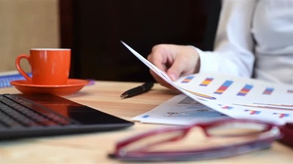Hand Of Businesswoman Sorts Stock Report And Analytical Documents