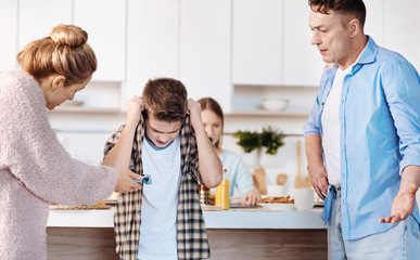 Carign furious parents punishing their son for smoking