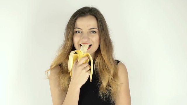 Woman eating a banana, isolated, steadycam
