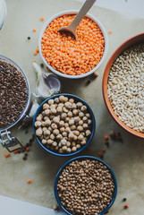 vegetarian food in ceramic bowls on rustic background
