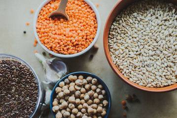 vegetarian food in ceramic bowls on rustic background