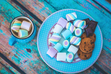 marshmallow cookies and chocolate on plate above view