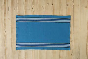 Wooden picnic table with blue dishcloth on