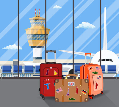 Travel suitcases inside of airport with a plane,