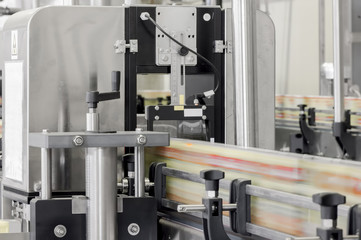 close up of conveyor belt in motion at production and bottling of drinks in tin cans. production and bottling of drinks in tin cans