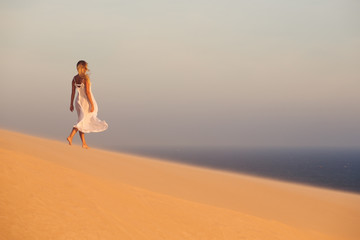 Beautiful woman in desert. Sand dunes.