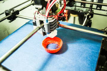 Objects printed by 3d printer. Automatic three dimensional 3d printer performs plastic modeling in...