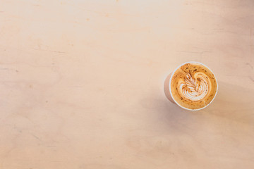 Latte with Latte art in coffee shop on wooden table