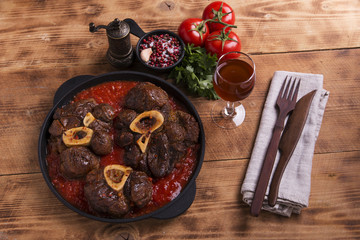 roasted meat on the bone Osso Buco in tomato sauce