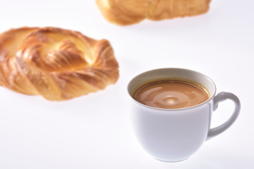 Coffee cream in a white cup on white background