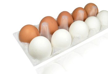 Preparing for Easter. Raw eggs of white and brown color lie in a transparent plastic package and...