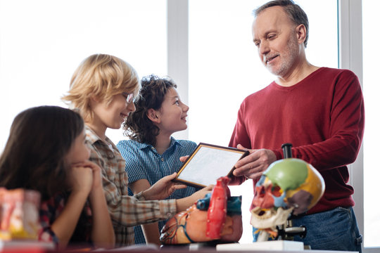 Enthusiastic original teacher awarding his students