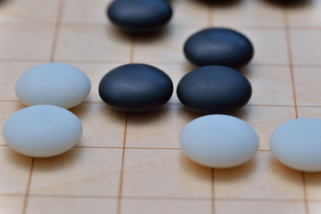 Fototapeta na wymiar GO game. GO is an abstract strategy board game for two players, in which the aim is to surround more territory than the opponent.