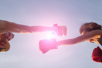 Beautiful athletic girl with boxing gloves hit high foot. sport, fitness, lifestyle and people concept.