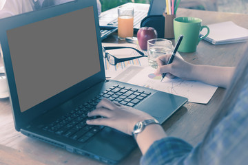 Business woman analyzing investment charts at morning time.