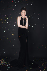Happy time, young smiling asian woman celebrating new year, wearing black dress