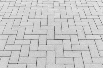 Paver brick floor also call brick paving, paving stone or block paving. Manufactured from concrete or stone for road, path, driveway and patio. Empty floor in perspective view for texture background.