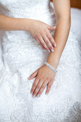 bride hand on white dress