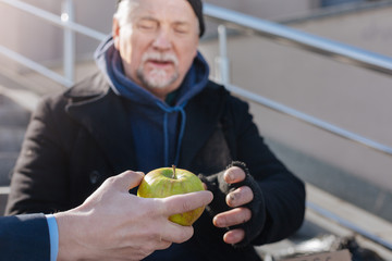 Happy man being glad of apple