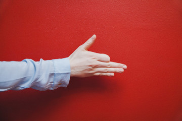 Hand gesture on red background