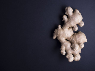 Fresh ginger root isolated on black background