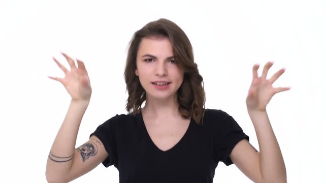Pretty young excited teenage girl showing biceps isolated on the white background