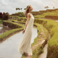 Fototapeta na wymiar Beautiful woman in white dress. Rice terraces.