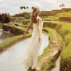 Fototapeta na wymiar Beautiful woman in white dress. Rice terraces.