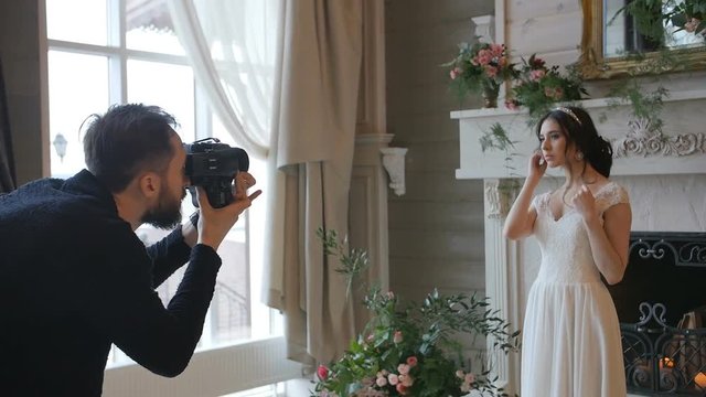photographer shooting with a medium forman film camera bride with a fireplace on the background
