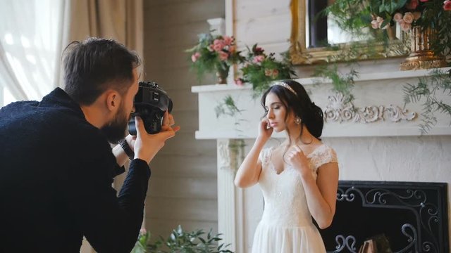 photographer shooting with a medium forman film camera bride with a fireplace on the background