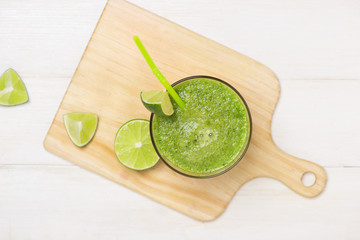 Detox concept. Glass jar of fresh drink green smoothie, spinach leaves, cucumber, apple, lime fruit.