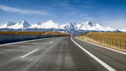 Car on highway and Tatra mountains, Slovakia