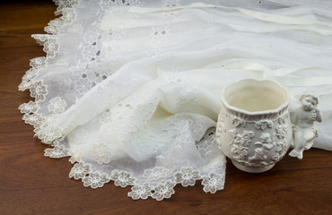 Christening lace gown  on wood table
