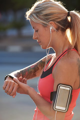 Sporty tattoo woman with fitness tracker sports watch