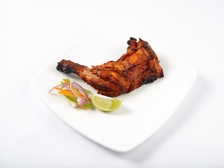 chicken tandoori served in a white plate on white background
