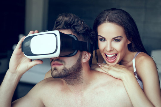 Sexy naked couple playing with VR headset, cinematic style, virtual reality at home