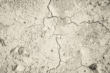 Top view of cracked and barren ground, clay desert texture.Color toned.