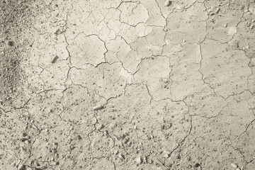 Top view of cracked and barren ground, clay desert texture.Color toned.