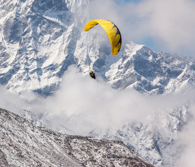 Paraglider flying against the mountain Lhotse (8516 m) - Everest region, Nepal, Himalayas