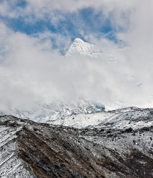 The view from the Chhukhung valley to snow covered peak in the cloudly weather - Everest region, Nepal, Himalayas