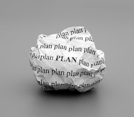 Crumpled paper ball with words Plan on gray background