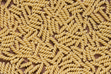 Raw macaroni on a wooden background. Mix pasta. Close up